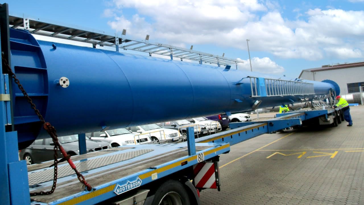 MAHLER large blue process column secured on a flatbed trailer during transport preparation at the plant yard.