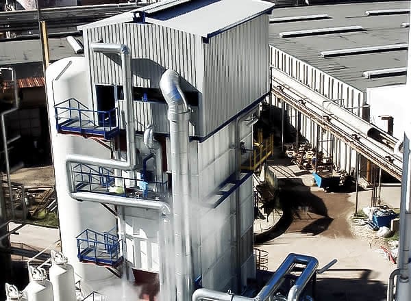 MAHLER Hydroform C plant tower with multiple blue-railed platforms and large silver exhaust piping in an industrial facility.