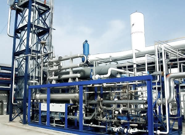 MAHLER Hydroform M modular gas treatment plant with blue steel frame, dense piping and vessels, and a tall tower, installed outdoors at an industrial site under a clear sky.