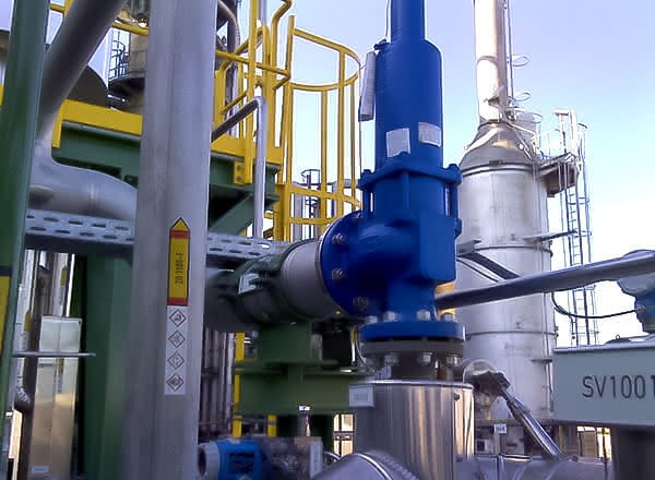 Close-up of a MAHLER process-gas membrane plant showing blue valve/actuator assembly, stainless steel piping, and access platforms within an industrial installation.
